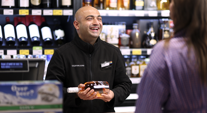 liquorland staff smiling to customer